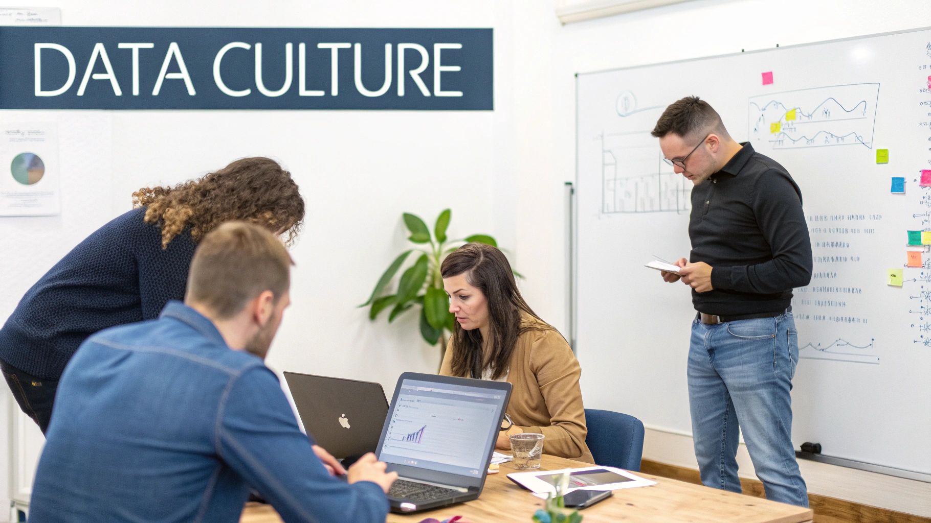 A diverse team of professionals collaborating in an office, analyzing data on laptops and a whiteboard, promoting a data-driven culture.